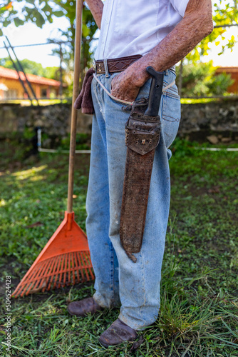 Farmer with rake  in Costa Rica with Machete  photo