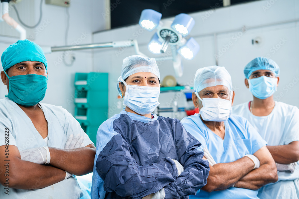group of surgeons standing confidently by looking at camera at operation theater - concpet of healthcare, teamwork, expertise and professional occupation group of surgeons standing confidently by looking at camera at operation theater - concpet of healthcare, teamwork, expertise and professional occupation