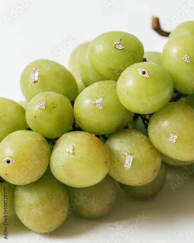 Bunch of grapes studded with earrings photo