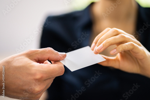 Person Hands Giving Visiting Card To Another Person