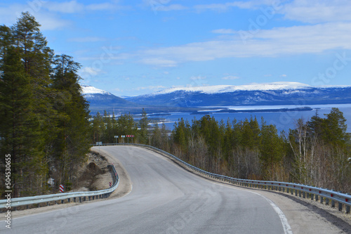 Landscape with road and snow-covered Mountain in May 