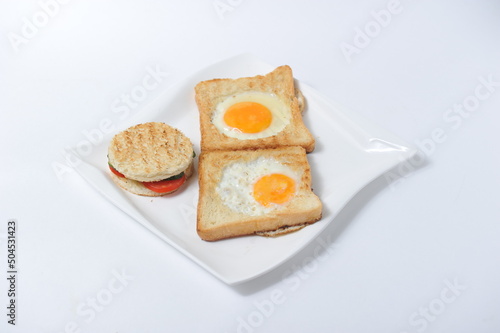 Toast with vegetables and scrambled eggs on a plate.