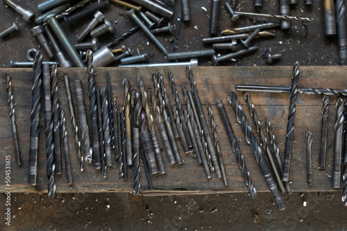 drill bits with screws, nails and blacksmith tools photo