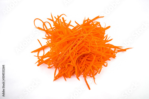 Grated fresh organic carrots on white background photo