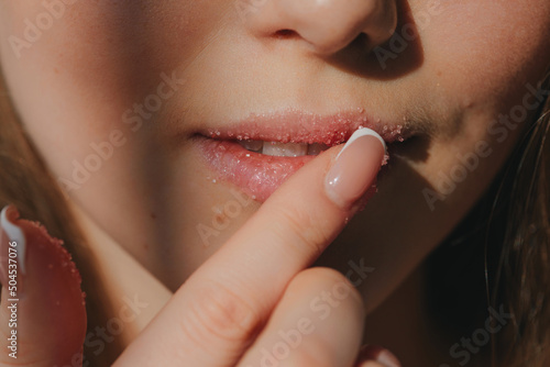 Anonymous woman applying lips scrub