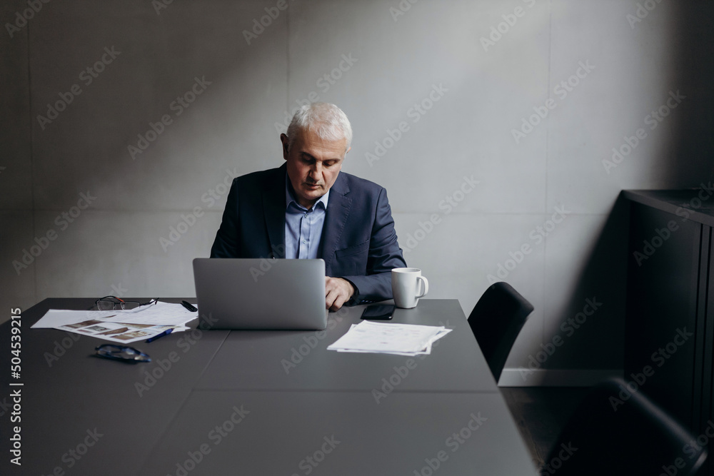 © Stereo Shot/Stocksy - Male entrepreneur working in boardroom © Stereo Shot/Stocksy - Male entrepreneur working in boardroom