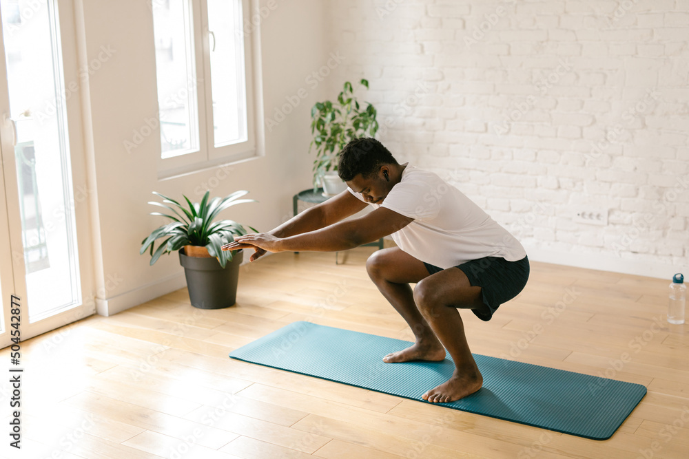 Young male working out indoors Young male working out indoors