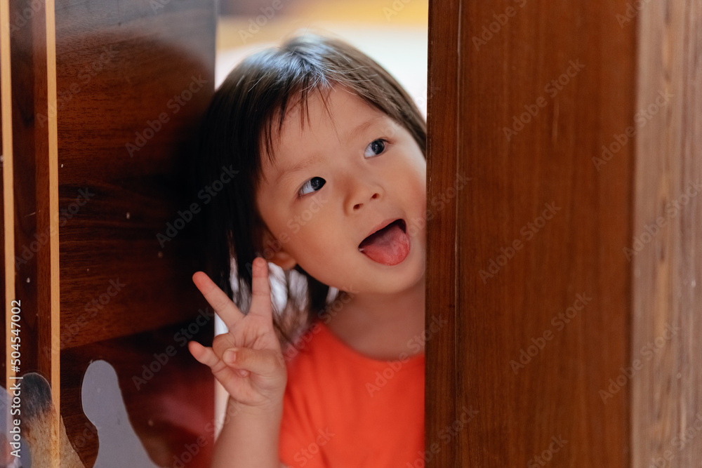 Cute little girl opens the door Cute little girl opens the door