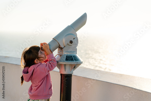 Little girl looking with monocular 