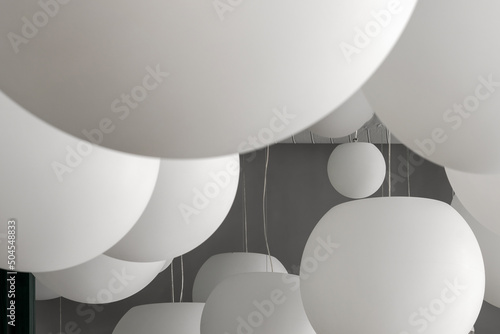 Closeup view at hanging lamps on gray wall background photo