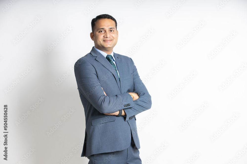 Portrait of a confident young indian business man in a suit standing with his arms cross, isolated on white studio background. successful asian male ceo of company, executive manager. blank space. - obrazy, fototapety, plakaty 