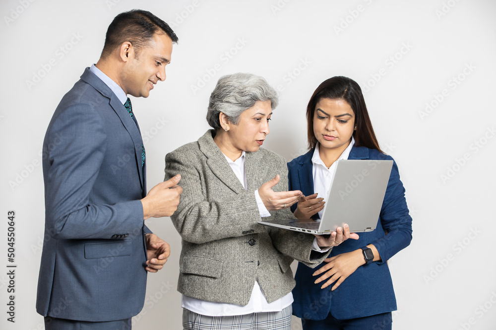 Group of indian business people working together on a laptop at isolated on white studio background. Asian female boss discuss on computer with employee Group of indian business people working together on a laptop at isolated on white studio background. Asian female boss discuss on computer with employee