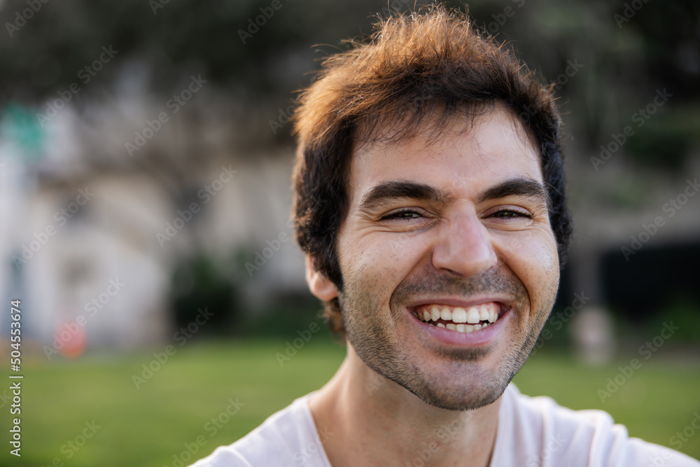 © Ameris Photography Inc./Stocksy - Expressive portrait of young man sitting in the park. © Ameris Photography Inc./Stocksy - Expressive portrait of young man sitting in the park.