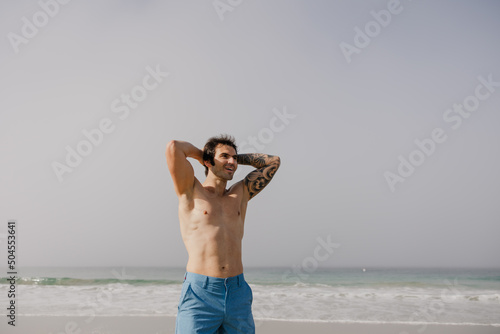 Man recovering after workout on the beach.