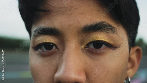 Closeup eyes of Asian gay man looking at camera