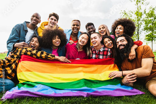 Happy diverse young friends celebrating gay pride festival - LGBTQ community concept photo