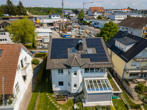 Aerial drone view of solar/photovoltaic panels on a houses roof top, Frankfurt Germany Spring