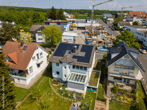Aerial drone view of solar/photovoltaic panels on a houses roof top, Frankfurt Germany Spring