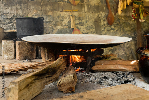 Firewood lit under a comal in a Mexican Kitchen photo