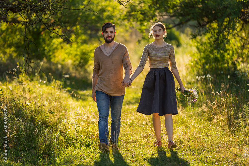 Fototapeta premium happy young couple walking in nature