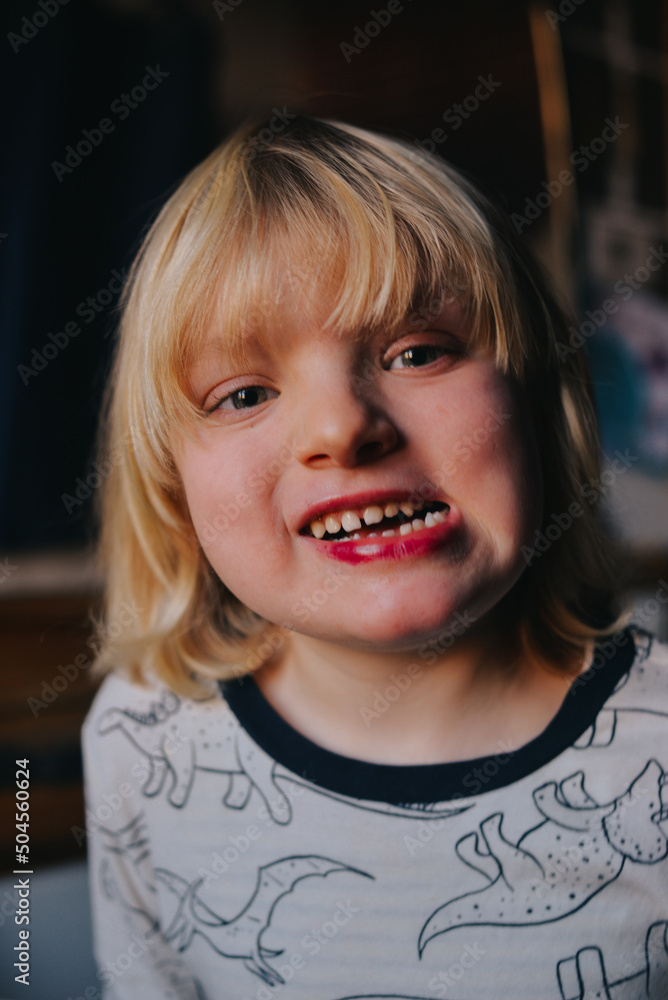 Smiling portrait of 5 years old kid with lipstick Smiling portrait of 5 years old kid with lipstick