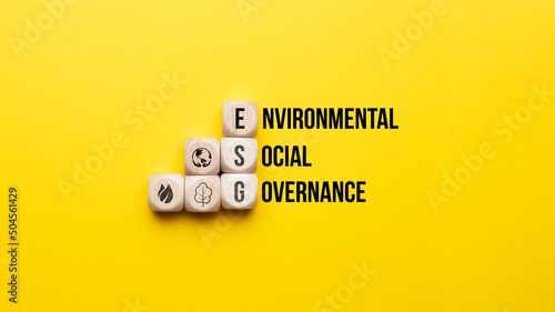 ESG or Environmental, Social, Governance. Text and icons on wooden cubes.