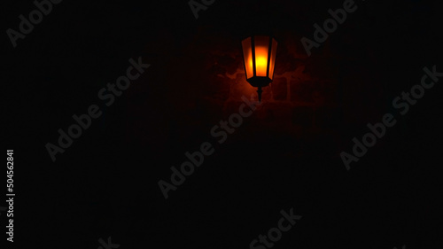 Night lamp on a brick wall