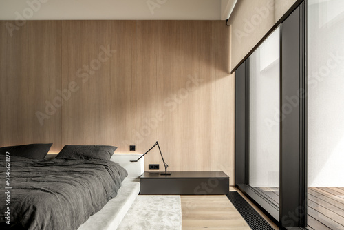 Interior of modern bedroom with large windows photo