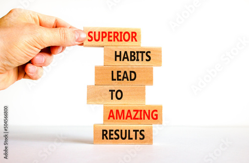 Good habits symbol. Wood blocks with words Superior habits lead to amazing results. Beautiful white background Businessman hand. Business motivational good habits and result concept. Copy space.