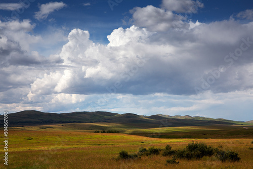 Summer clouds build up over the prairies .
