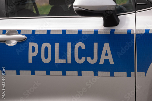 Obraz na płótnie Police car side door sign, letters in Polish language, Policja means Police. w salonie