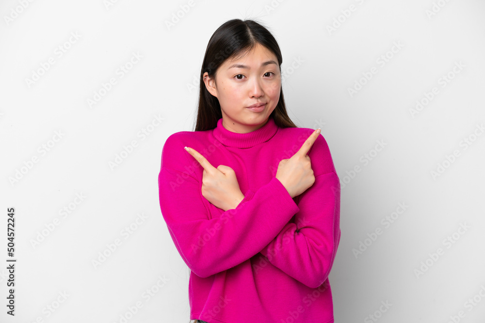 Young Chinese woman isolated on white background pointing to the laterals having doubts Young Chinese woman isolated on white background pointing to the laterals having doubts