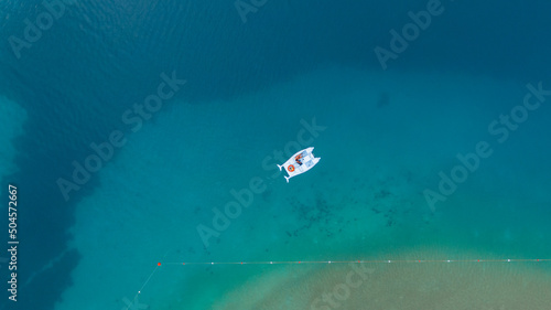 overhead view of a man on the pedal boat in azure lagoon