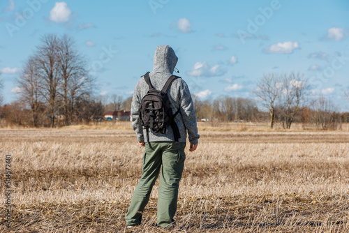 Man walking on field against sky