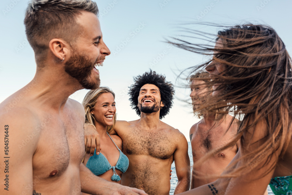 Multi-ethnic friends having fun at the beach Multi-ethnic friends having fun at the beach