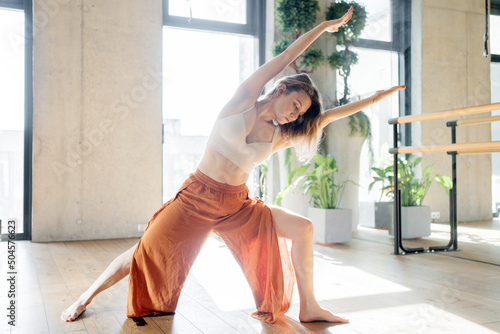 Female Yoga Trainer does workout, Flexible Body aerobics fitness club