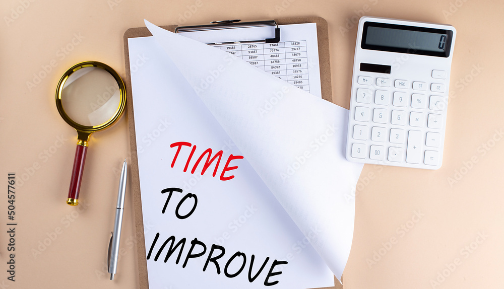 Clipboard with chart and text TIME TO IMPROVE with magnifier ,calculator on beige background Clipboard with chart and text TIME TO IMPROVE with magnifier ,calculator on beige background