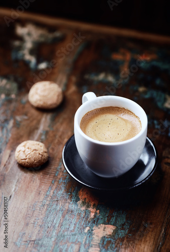 Cup of coffee with Amaretti (Italian biscuits) on rustic wooden background. Copy space.