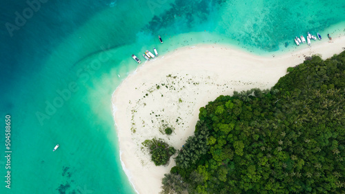 Above view of  the Tropical island beach with  sand as seashore as the tropical island in a coral reef ,blue and turquoise sea with the boats background photo