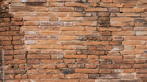 The background of an old brown brick wall in an ancient Thai temple.