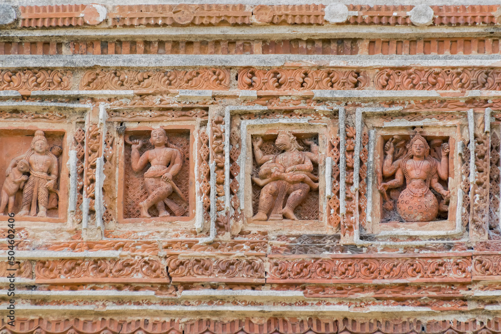 Terracotta decorations on the walls at Pratapeswar Temple at Kalna, West Bengal, India. Terracotta is a brownish-red clay that has been baked and is used for making things.