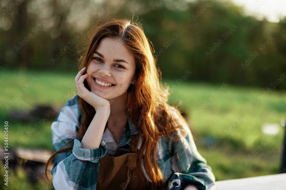 A woman laughing and smiling in nature in a green park A woman laughing and smiling in nature in a green park