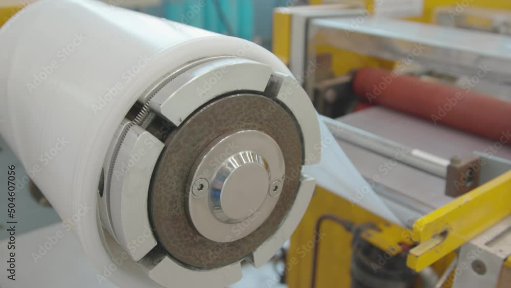 Plastic cast film extrusion line roller and winding unit. Yellow