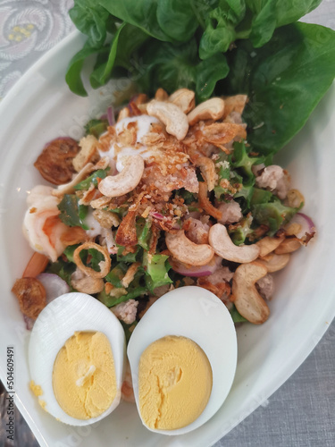 winged bean shrimp salad with eggs on the white bowl