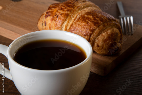 Fototapeta Naklejka Na Ścianę i Meble -  Close-up of croissant with a cup of whole coffee