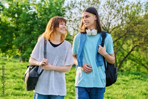 Portrait of teenage young guy and girl students outdoor