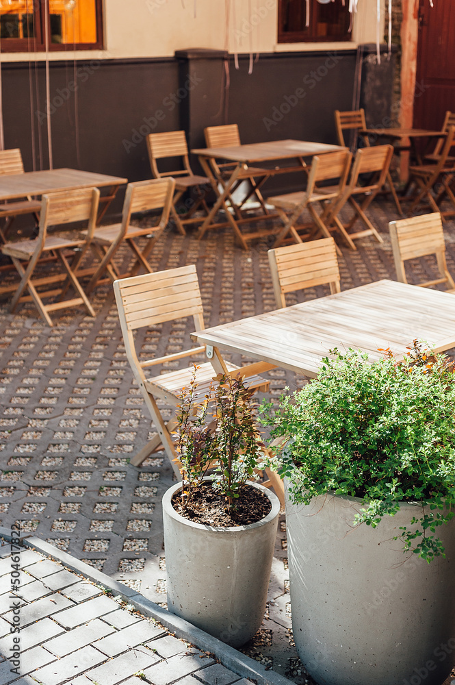 Fototapeta premium exterior of a cozy little local cafe on the streets of Ukraine, wooden table and tables