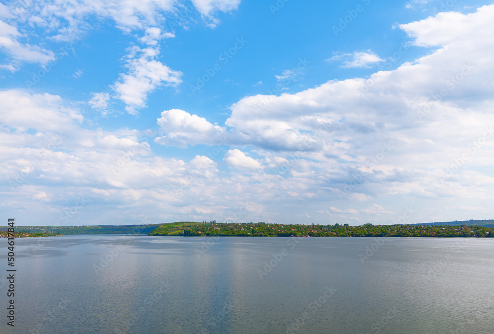 Coastal landscape in summer . Village at the riverside