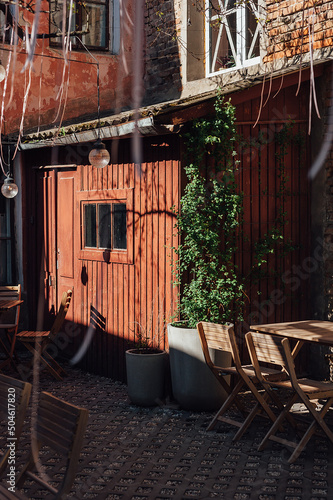 exterior of a cozy little local cafe on the streets of Ukraine, wooden table and tables