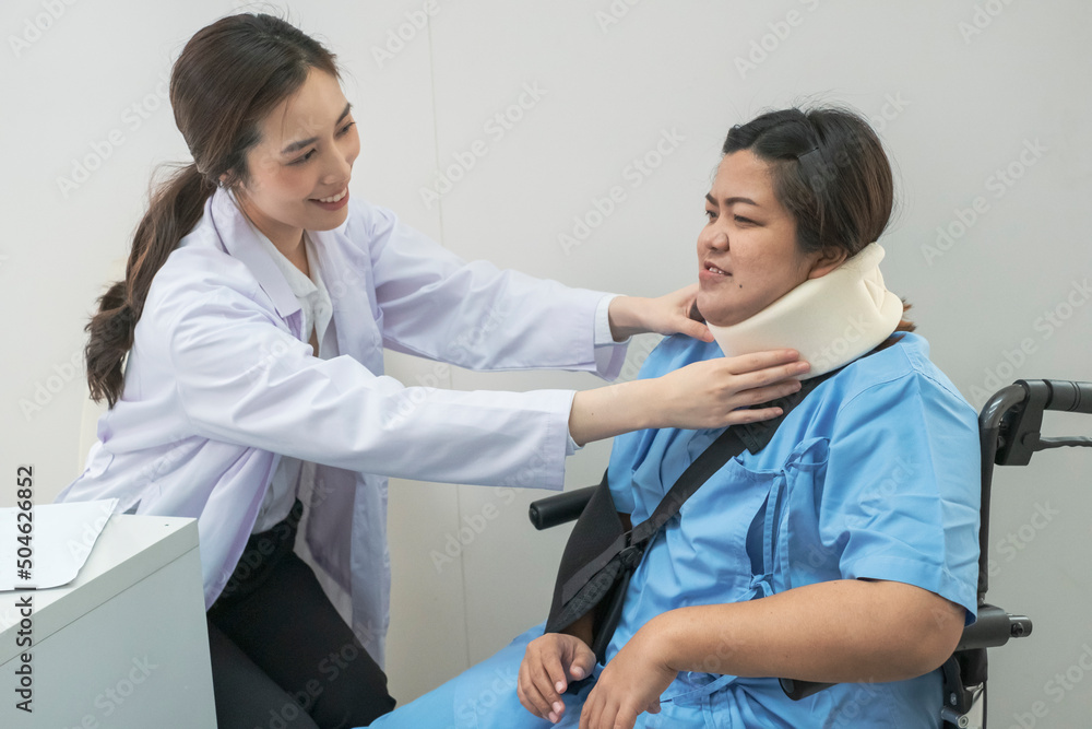 Fototapeta premium Young Doctors checking Patient after treatment. Young Female Doctor checking on patient after neck pain. Doctor writing a prescription to her patient. Female doctor talk consult patient.